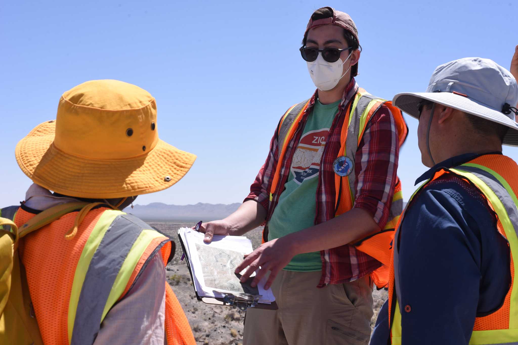 Zach More discusses data with colleagues at Potrillo Volcanic Field in New Mexico, April 2022