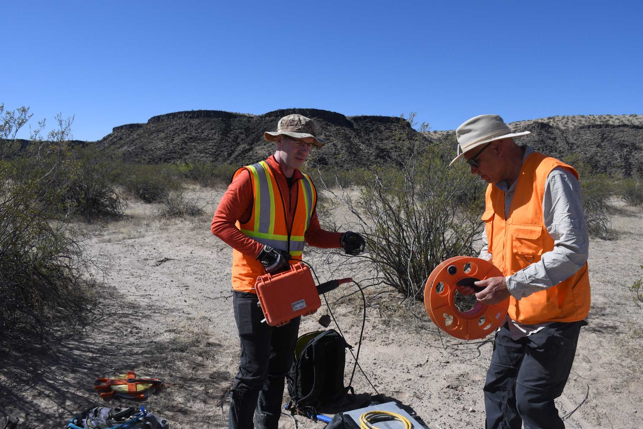 Ernie Bell (left) and John West (right) setting up geophones within the volcanic crater.